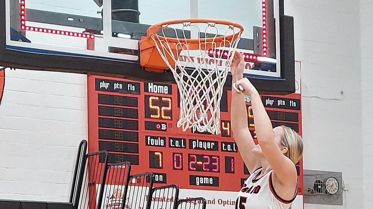 Highland’s Grace Wilke cuts down the net after the teams IHSA Class 3A regional championship win over Waterloo on Feb. 17 at Highland High School. Wilke enjoyed a tremendous career at Highland and she now will attend the University of Kentucky in the fall and major in accounting.