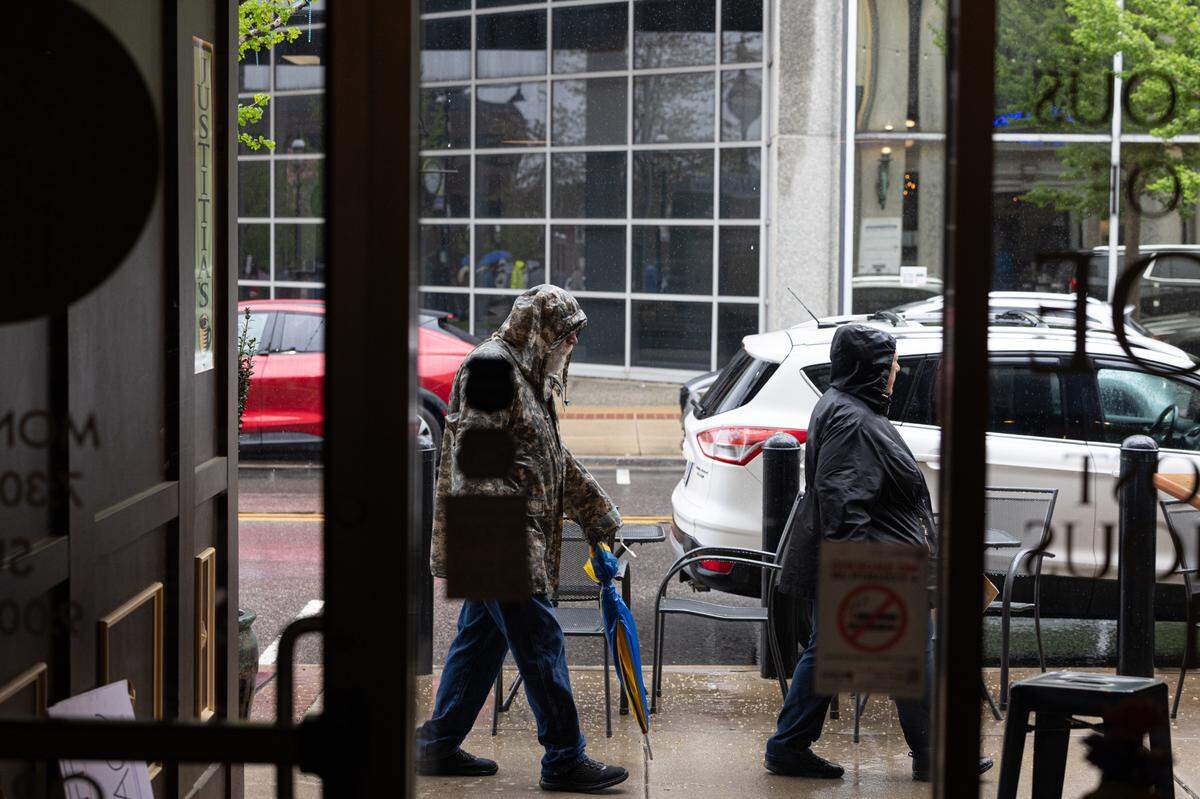 Demonstrators returning from Saturday’s protest at Downtown Public Square pass by Judicia’s coffee shop on Main Street in Belleville.