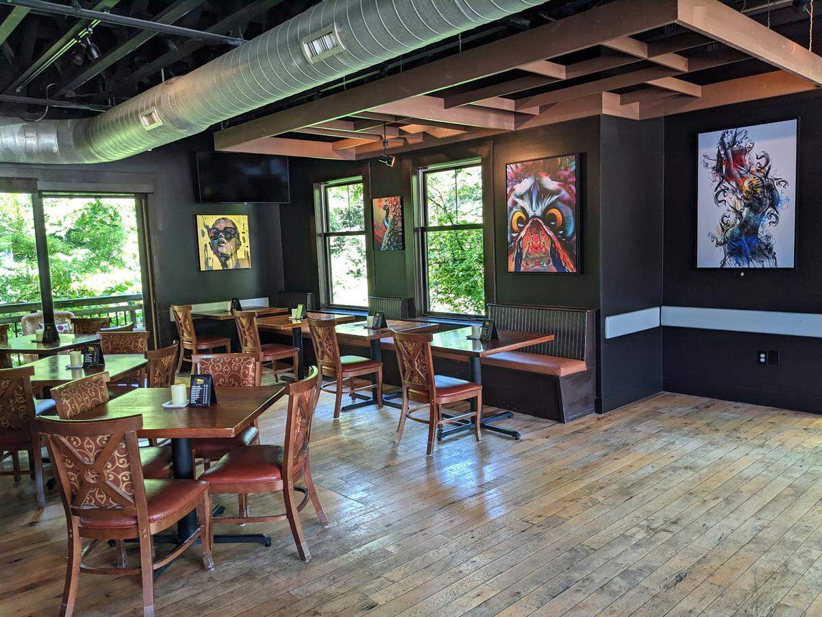 View of the dining area and some artworks at Reine in Edwardsville