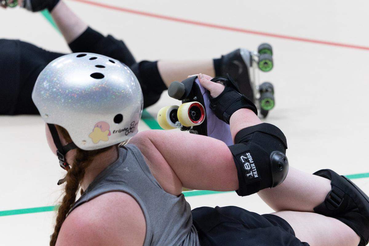 Members of Confluence Crush stretch during practice in Troy.