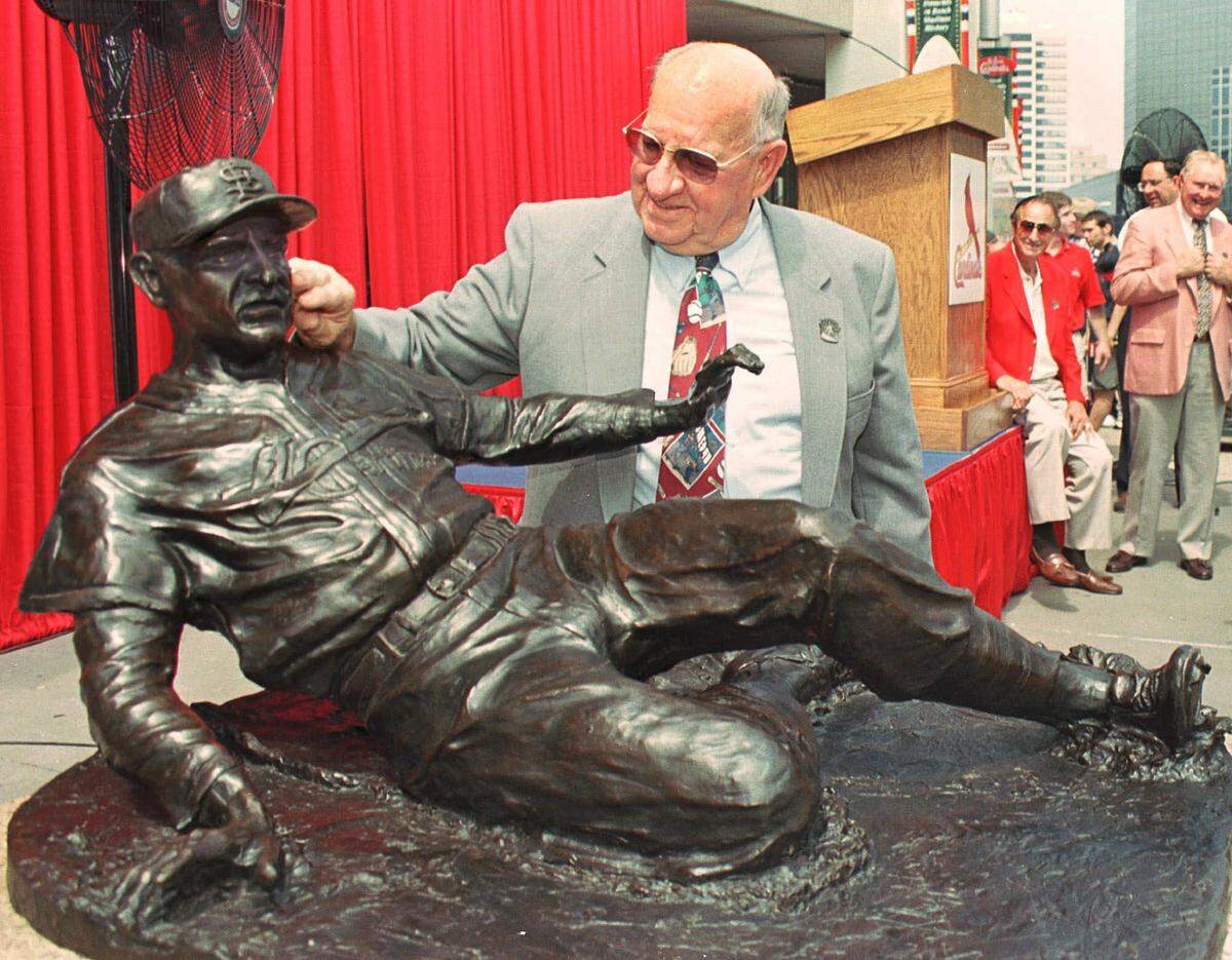 St. Louis Cardinal great and hall-of-famer Enos Slaughter admires a statue depicting his famous slide to win the 1946 World Series after it was unveiled Sunday, July 18, 1999 at Busch Stadium.