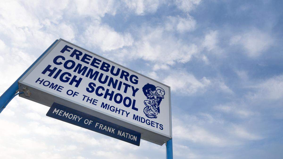 A sign outside of Freeburg Community High School with the subtext “home of the mighty midgets.” The school’s mascot has been a source of controversy and media attention for years.