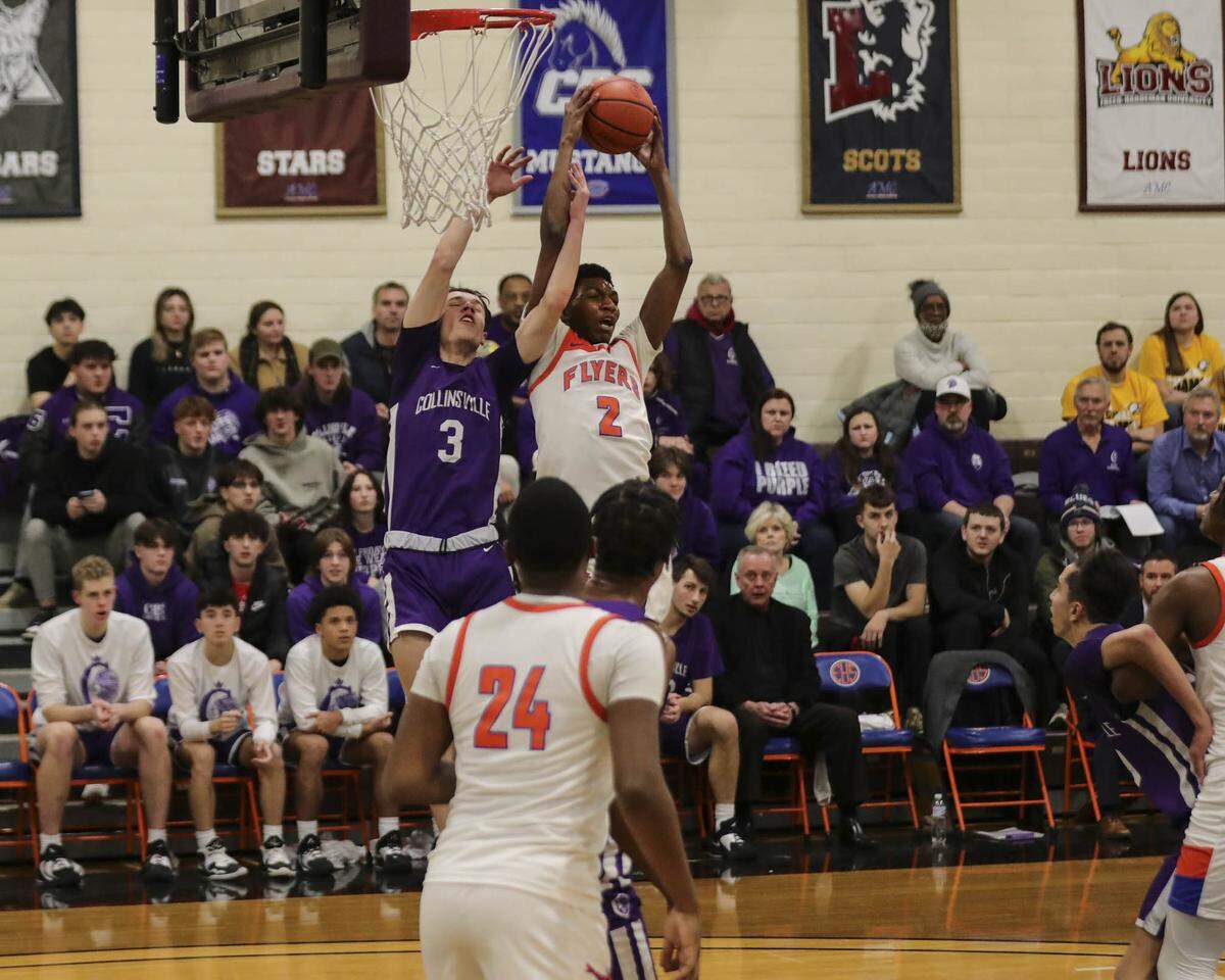 D’Necco Rucker of East St. Louis hauls down a rebound during Friday night’s Southwestern Conference game against Collinsville. The Kahoks ultimately posted a 56-49 victory.