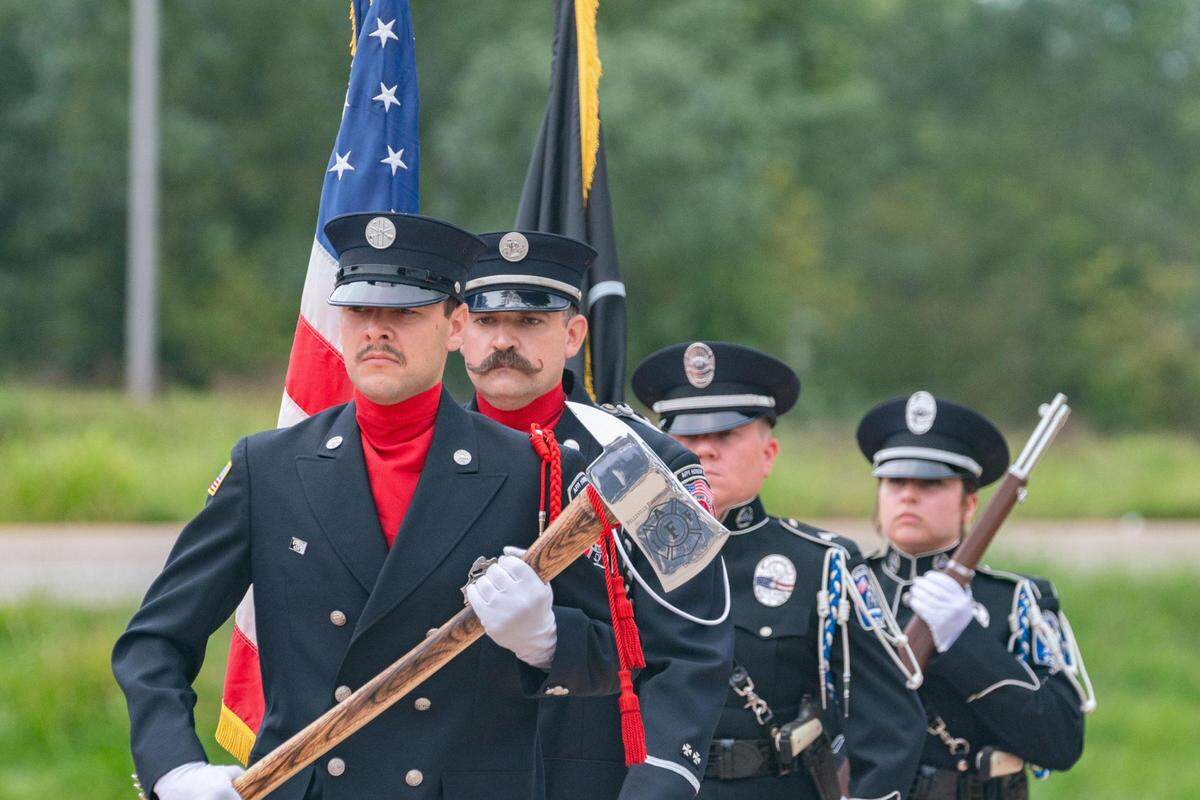 Belleville, Ill. fire department color guard marches forward to display colors during a 9/11 memorial on Sept. 11, 2023.