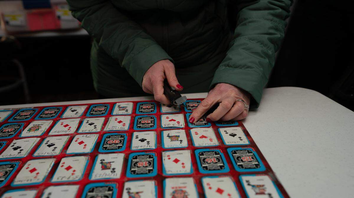 A teacher at Sts. Peter and Paul Catholic School cuts a card from the Queen of Hearts board in Waterloo, Ill. on Jan. 30, 2024.