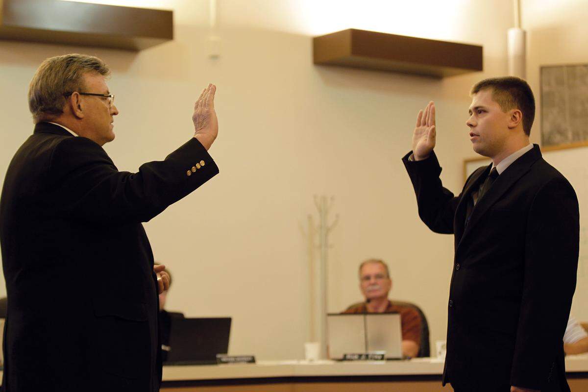 Highland Mayor Joe Michaelis swears in Shane Zobrist as the newest police officer for the city.