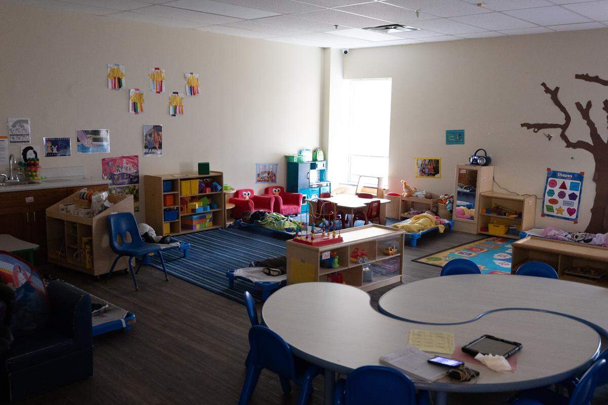 Children lay asleep during nap time at UNI-Pres Kindercottage child care in East St. Louis.