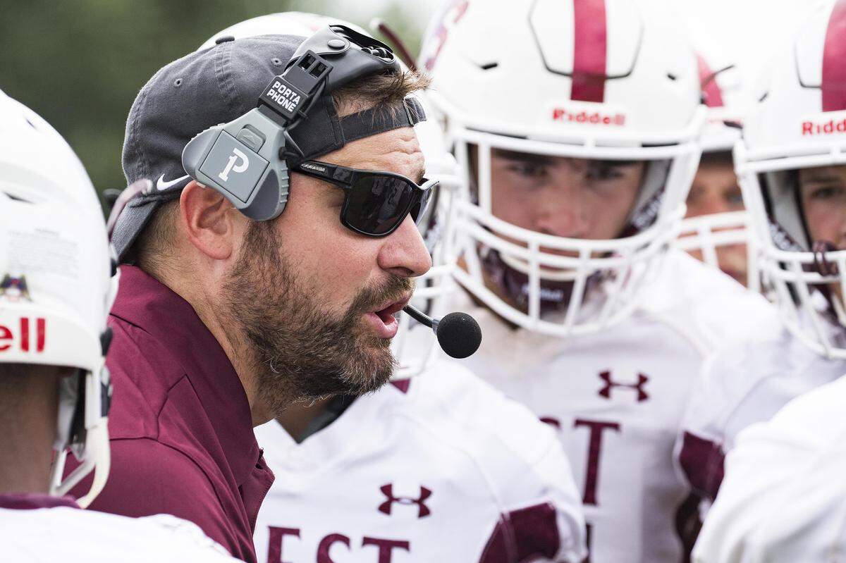 First-year Belleville West head coach Bryan Edgar talks to his squad during their game Saturday against Riverview Gardens. The Maroons made a winner of Edgar in his debut, posting a 40-2 win.