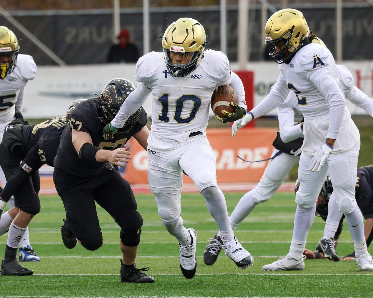 Althoff’s Dierre Hill Jr. carries the ball during the Crusaders’ 57-14 win over Lena-Winslow for the IHSA Class 1A title at Hancock Stadium on the campus of the Illinois State University.