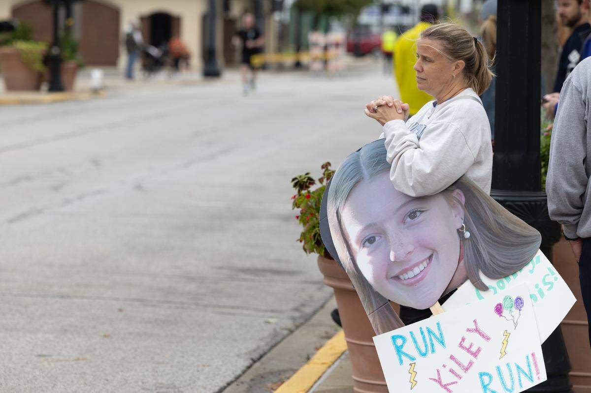 Michell Eckert of Cincinnati, Ohio stands by and waits for her daughter Kiley near the finish line of the Belleville Marathon on Sept. 28, 2024. “She trained a lot during the summer and was nervous about it, but I knew she could do it,” Eckert said.