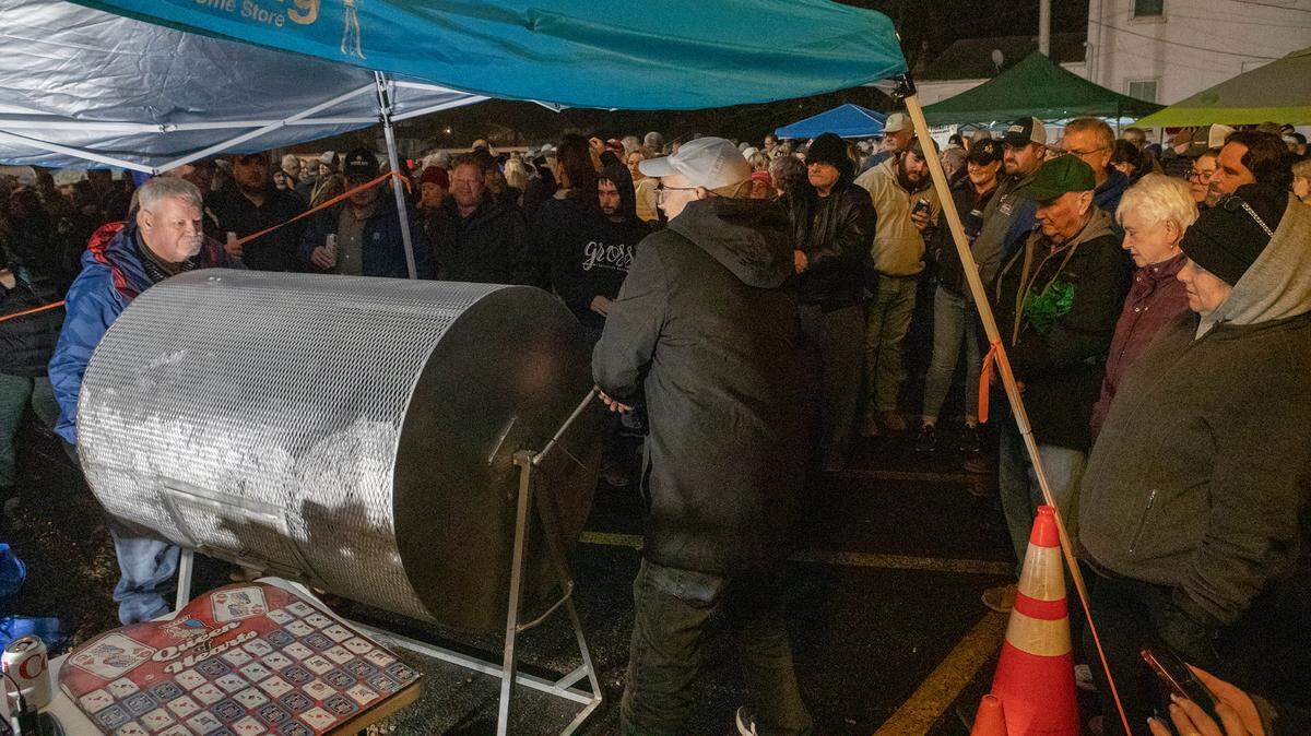 This file photo from Dec. 6 shows organizers spinning a barrel full of tickets for the Queen of Hearts raffle in Waterloo.