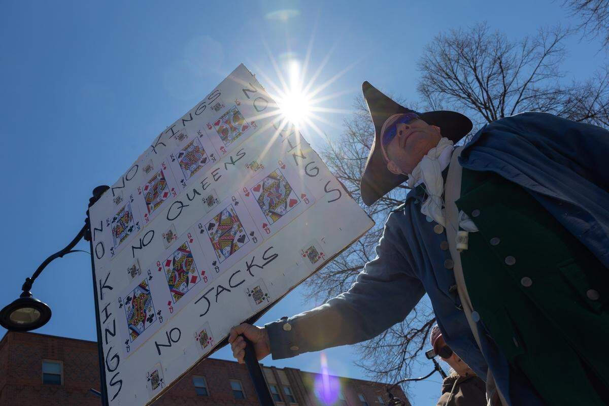 A protester wears a Revolutionary War soldier’s costume in front of the St. Clair County Courthouse on Saturday during a No Kings protest. Others dressed like the Statue of Liberty and characters from “The Handmaid’s Tale.”