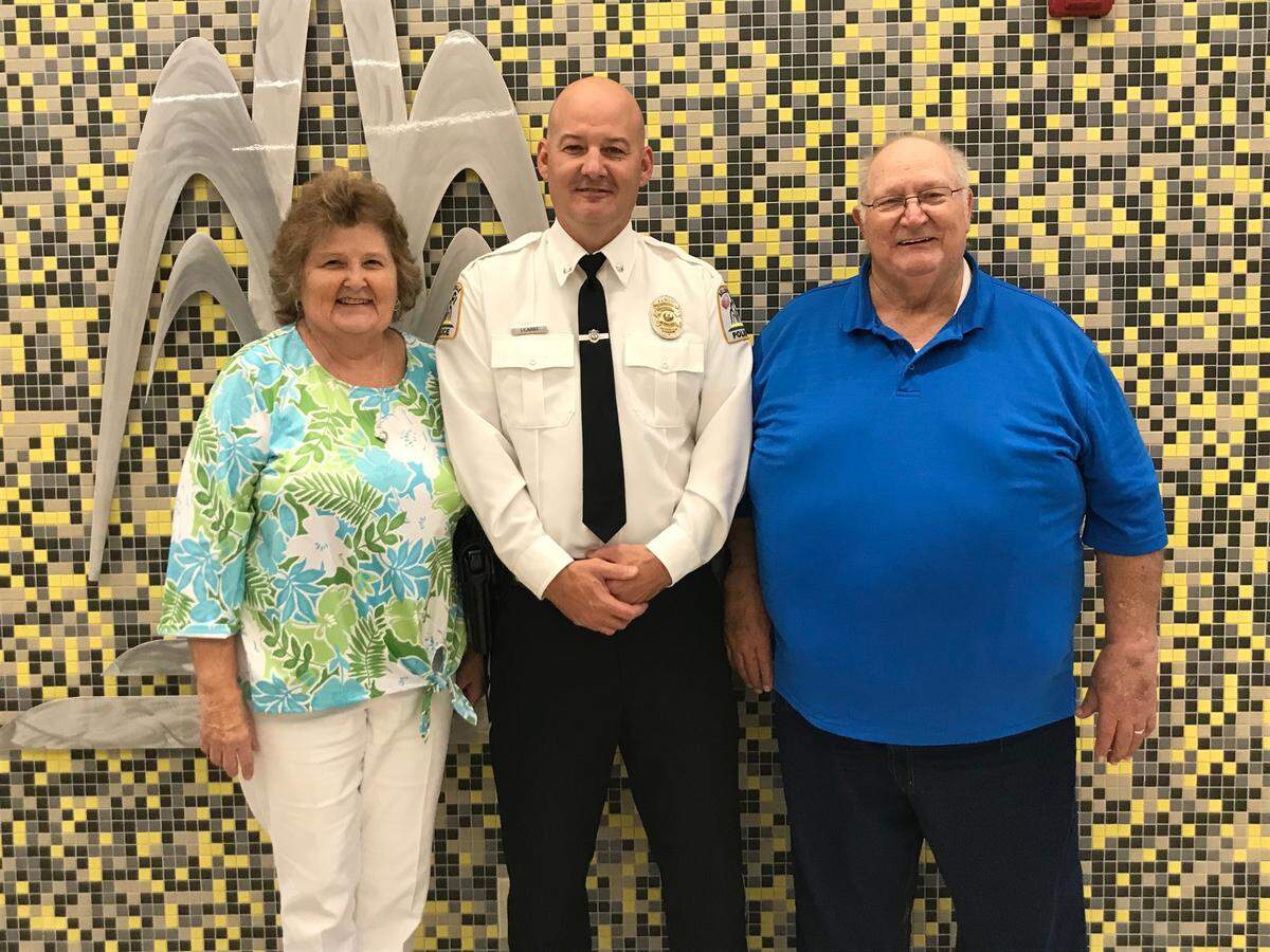 Assistant Police Chief Matt Eiskant, center, poses for photos with his mother and father, Juanita and Lonnie Eiskant, at Belleville City Hall on Monday night, shortly after the City Council approved his appointment as police chief.