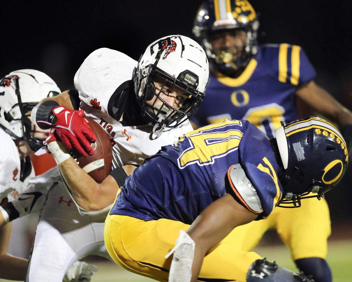Edwardsville’s De’Shawn Larson carries the ball during Saturday night’s IHSA Class 8A playoff game against O’Fallon. The Tigers defeated the Panthers 43-36.