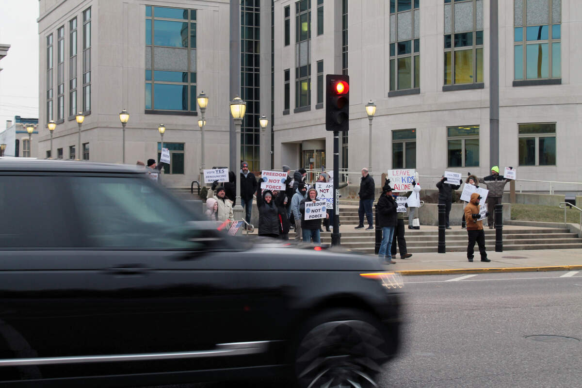About 25 people rally outside the Madison County Courthouse on Jan. 19, 2022, in support of a Madison County Board resolution “denouncing” COVID-19 vaccine mandates.