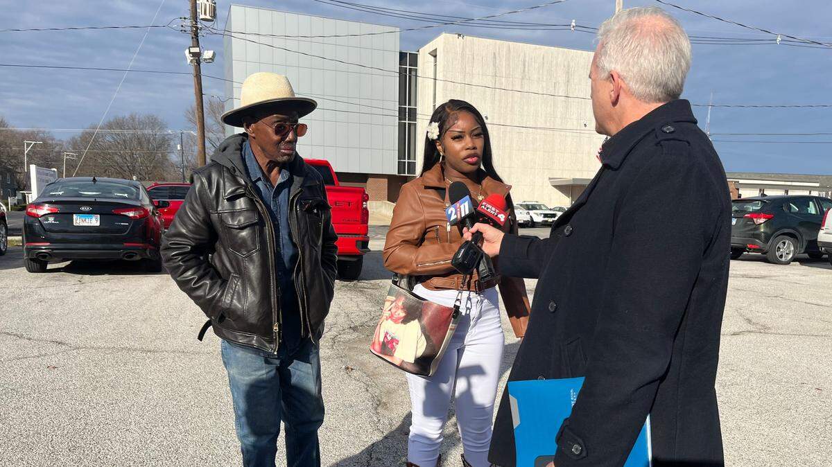 A TV news reporter interviews Carmillya Butler and her father, James Gibson, on Thursday outside Madison County Criminal Justice Center in Edwardsville after Roger Sutton was sentenced for the murder of her mother, Patrenia Butler-Turner. Her purse has a photo of Butler-Turner on it.
