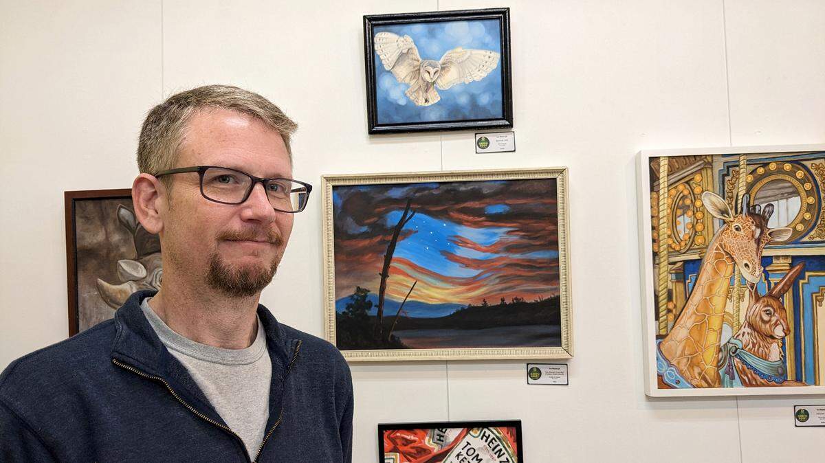Tom Wodarczyk, owner of Green Root Gallery at 125 E. Main St. in Belleville, stands in front of a display of his own work.