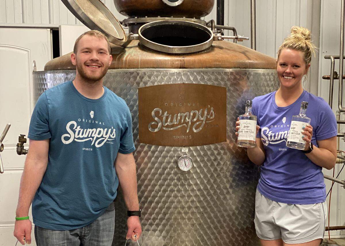 Devin Hemmer and Emilie Schmersahl work at Stumpy’s Spirits, a liquor distillery in Columbia that’s being used to make hand sanitizer during the coronavirus pandemic.
