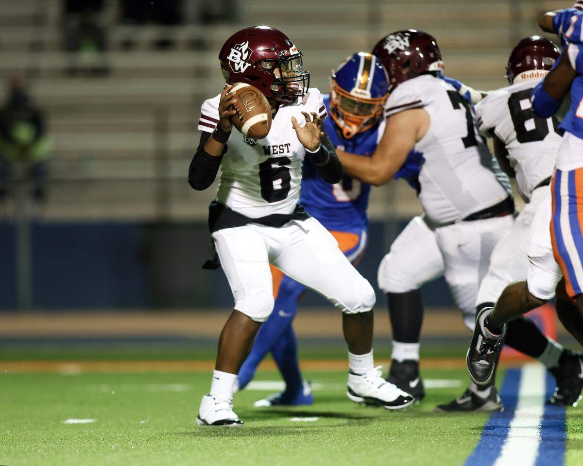 October 4, 2024 - East St. Louis Il, - Belleville West quarterback Bernard Chapman looks for an open receiver during Friday night’s Southwestern Conference matchup between Belleville West and East St. Louis. [Photo: Chris Johns]