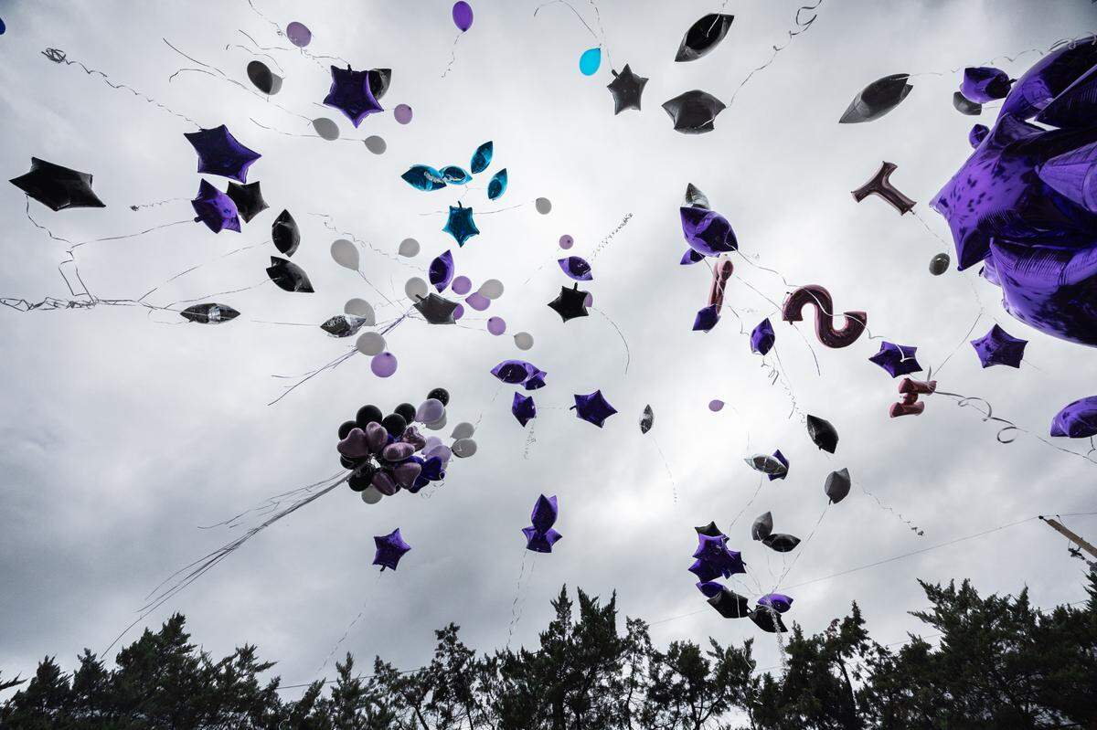 Friends, family and coworkers of Latasha Johnson, a victim of an alleged hit-and run Wednesday, release balloons in Cahokia Heights, Ill. on Sept. 13, 2024.