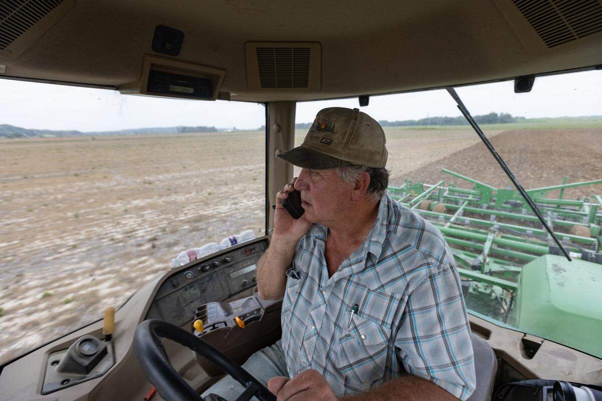 Williams takes a call from Renshaw while he plants soybeans on his farm.