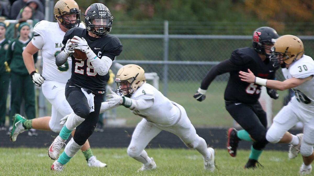 Senior running back Brady Feltmann gains yardage in a second-round playoff win over Mattoon.