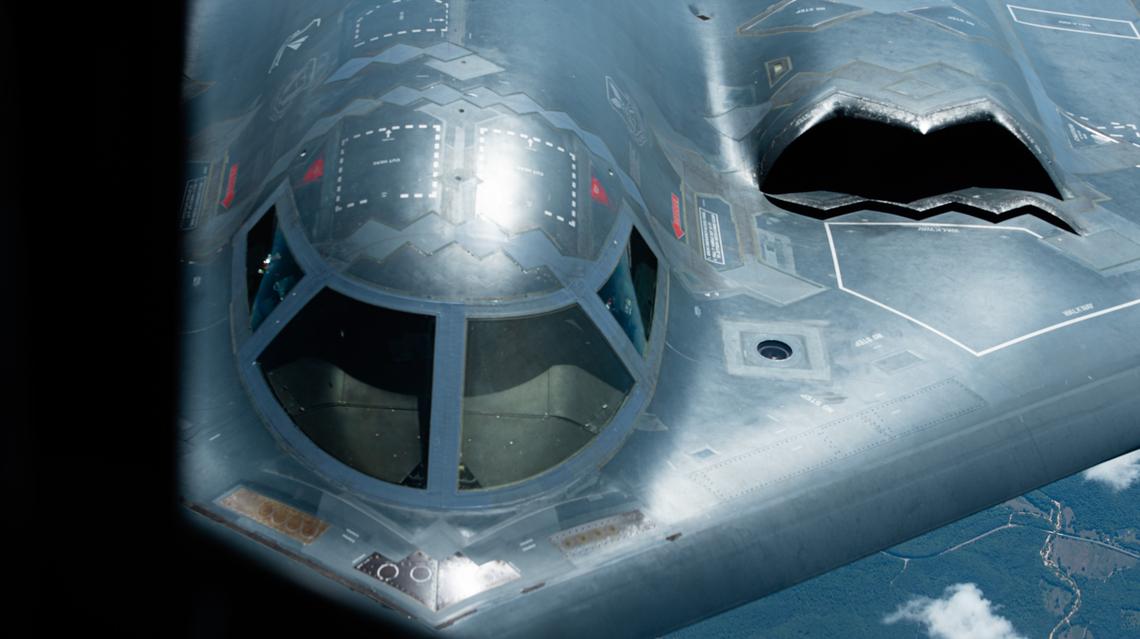 A B-2 Spirit Stealth Bomber from the 509th Bomb Wing, Whiteman Air Force Base, Missouri, flies behind a KC-135 Stratotanker from the 126th Air Refueling Wing on Scott Air Force Base during a commemorative flight marking the 100-year anniversary of air refueling June 27. The B-2 Spirit is a versatile bomber with the capability to deploy both conventional and nuclear munitions, signifying a significant advancement in the U.S. bomber modernization program.