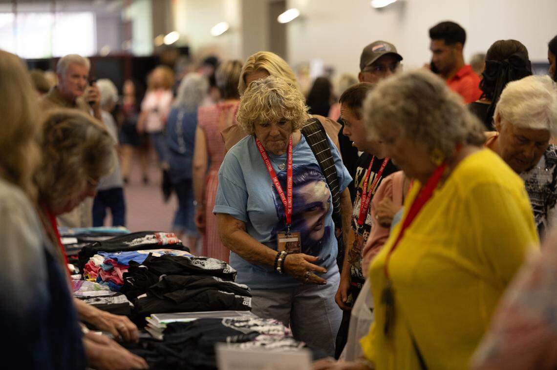 Elvis fans line up to look at merchandise before the performances start.