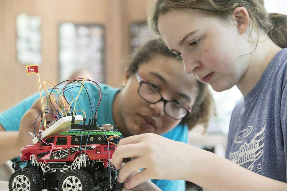Girl Scouts Jade Bengtson, 12, and Maya Henfling, 11, build a moon rover during a STEM camp at Camp Torqua near Edwardsville in the summer of 2019.