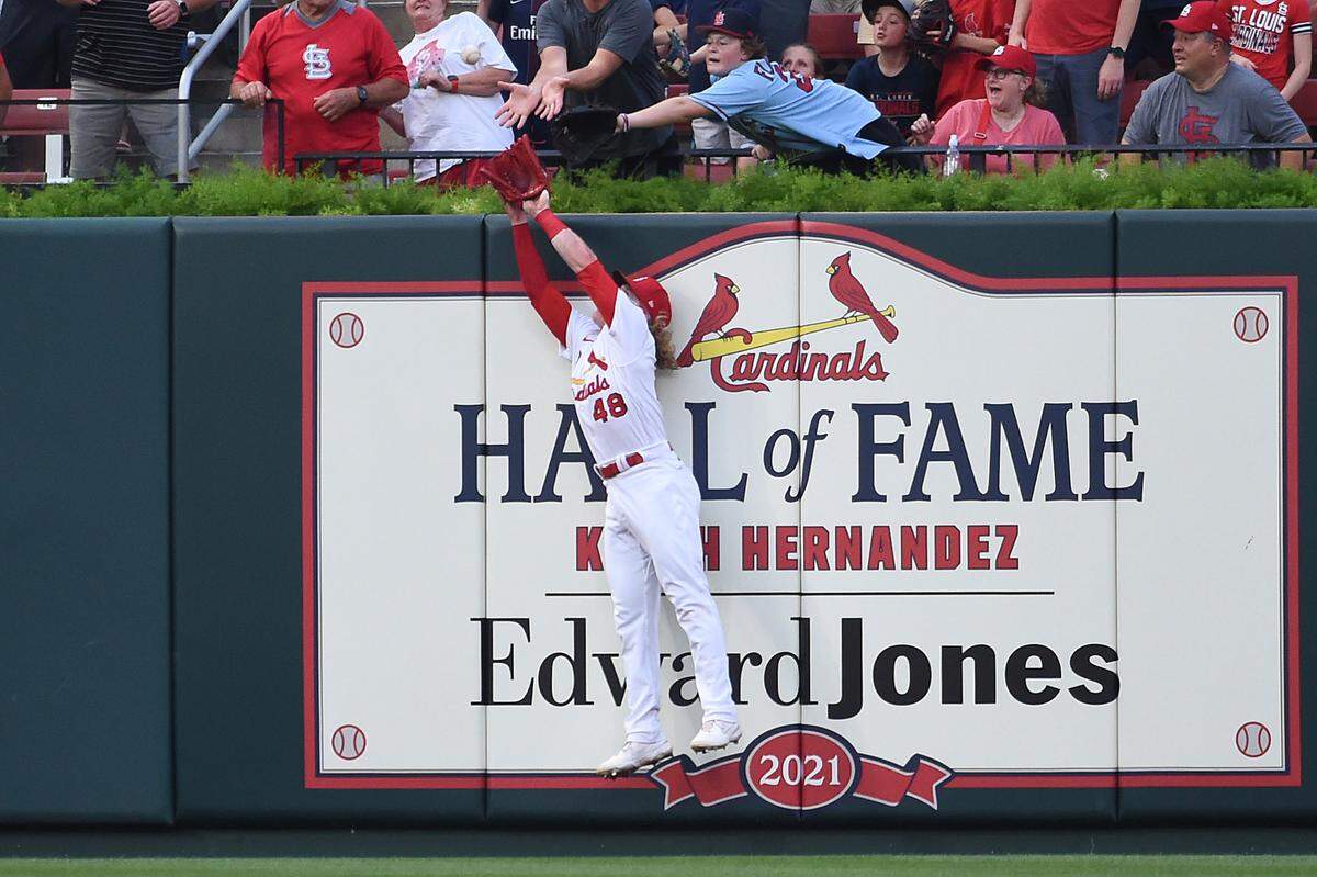 St. Louis Cardinals center fielder Harrison Bader leaps at the wall, catching a ball hit by Chicago Cubs’ Willson Contreras during the first inning of a baseball game Wednesday, July 21, 2021, in St. Louis. (AP Photo/Joe Puetz)