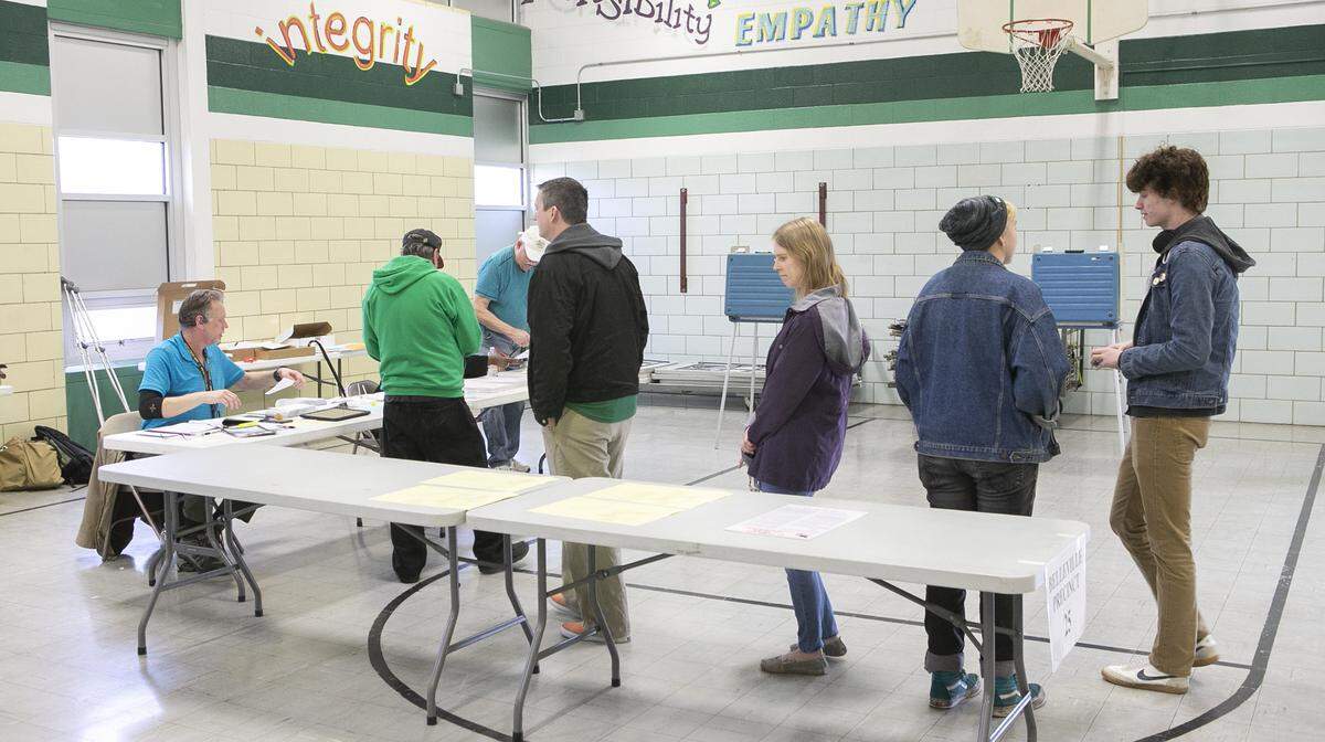 Voters lined up at the polling place inside Douglas Elementary School in Belleville during Tuesday’s primary election. Judges and other staff were using a variety of methods to disinfect and prevent the potential spread of coronavirus, which causes COVID-19.