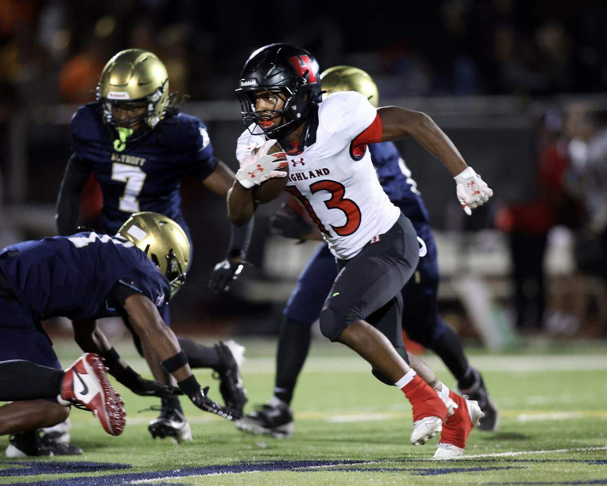 Highland's Carter Harris carries the ball during Friday night’s non conference matchup against Althoff in Belleville.