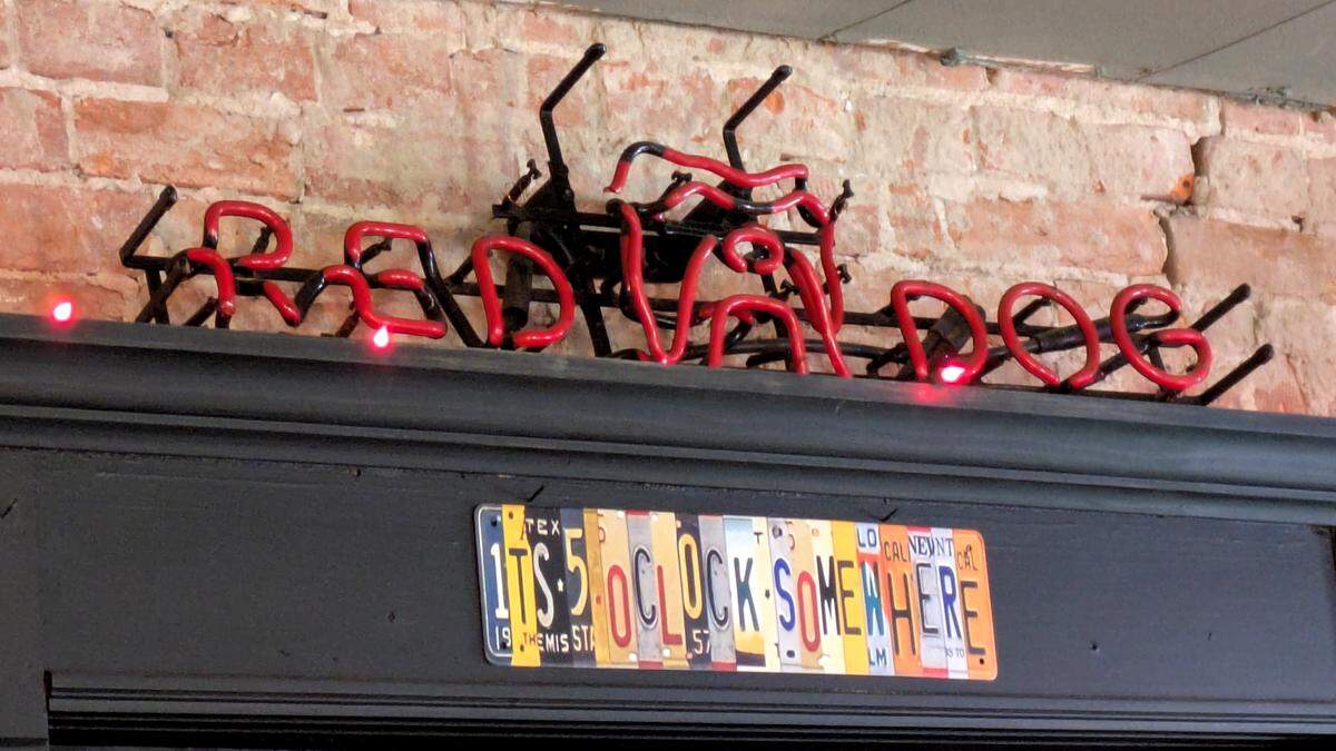 The bar at The Roost decorated with fun signs