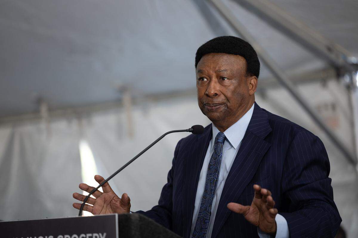 Ed Hightower speaks to a crowd during a groundbreaking ceremony for a grocery store in Venice, Ill.