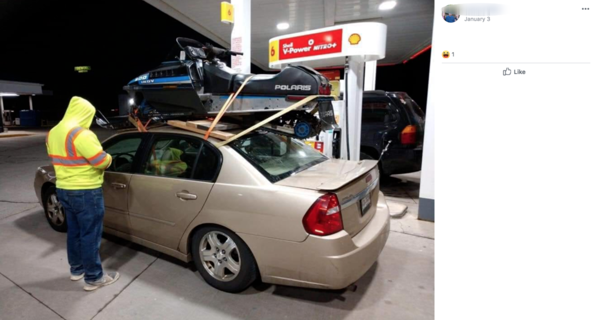 Tommy Mecher, 22, says he strapped his snowmobile to the roof of his car because it was cheaper than renting a trailer for his 400 mile trip to Michigan.