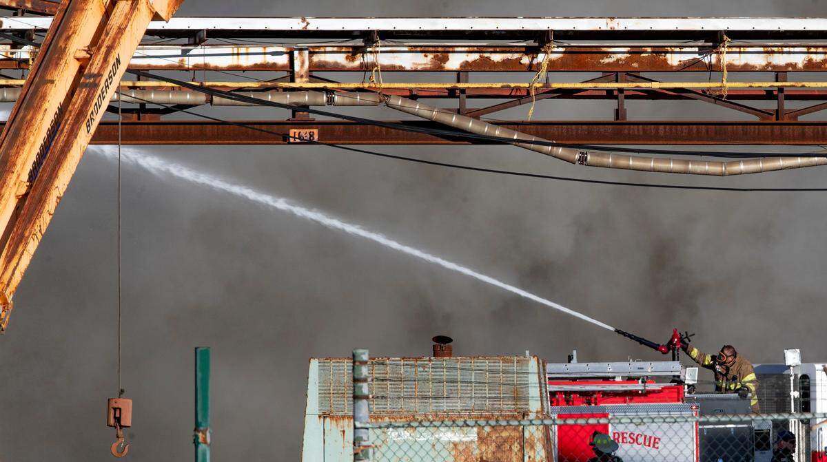 A firefighter works the deck gun at an industrial fire in Sauget, Illinois.