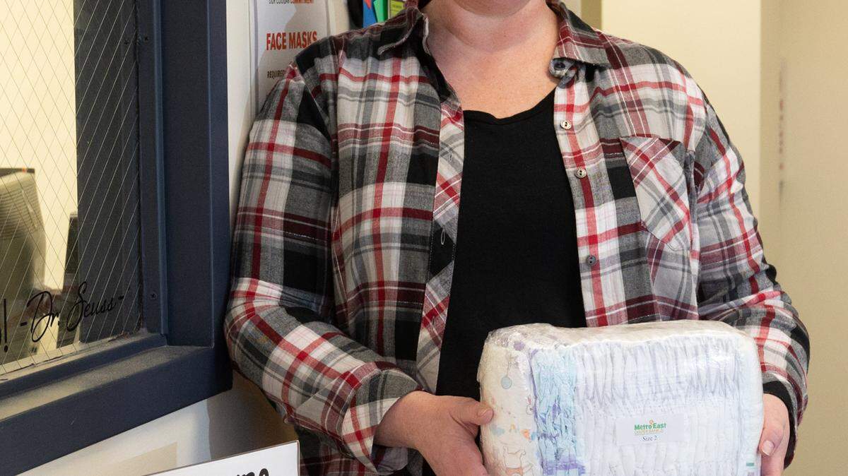 Sarah Kirkpatrick, director of the SIUE East St. Louis Learning Resource Center (LRC) and Campus Engagement, displays some of the free diapers that the LRC is offering the community.