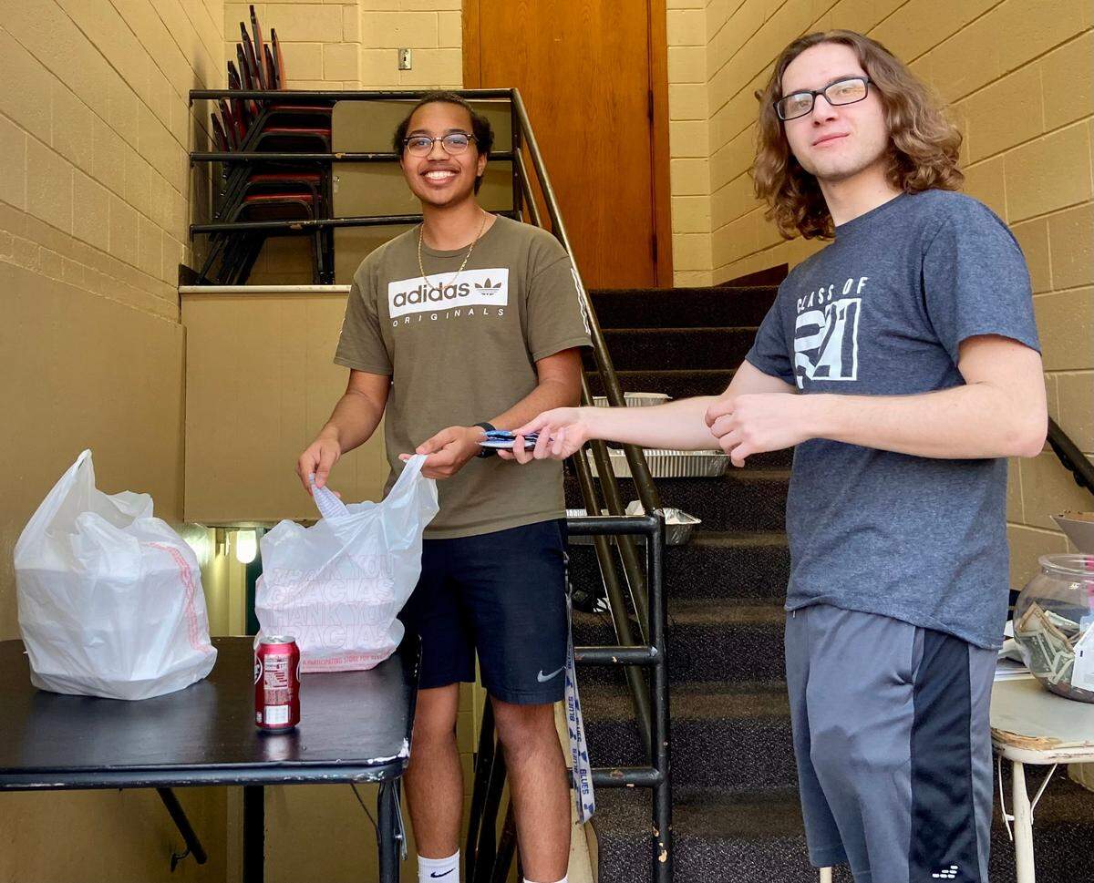 Drew Moran and Logan Coulter work the pick-up line out in the parking lot during the O’Fallon Knights of Columbus fish fry. The Knights of Columbus sponsors a fish fry every Friday during the year, with the operation kicking into high gear during the six weeks between Ash Wednesday and Easter Sunday for Lent.
