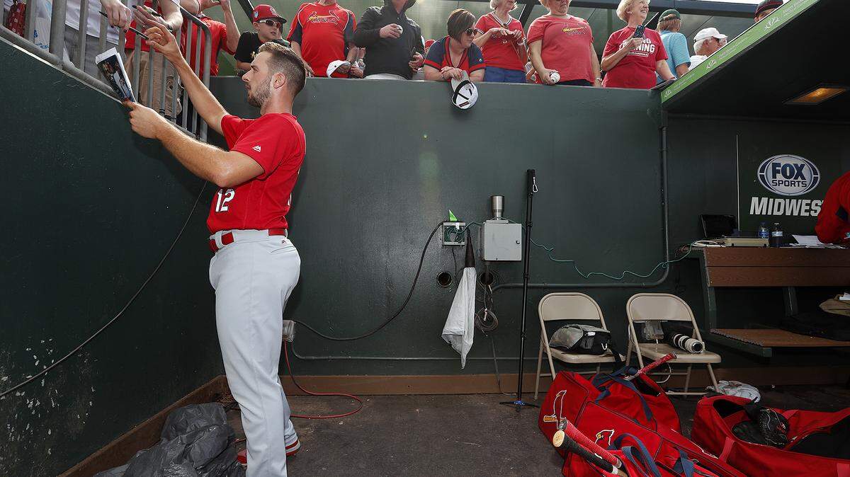Cardinals shortstop Paul DeJong signs autographs for fans at the team's spring training complex in Jupiter, Fla. The Cardinals added DeJong to their growing 10-day disabled list Friday. DeJong fractured a bone in his hand after being hit by a pitch during the Cardinals' loss to the Philadelphia Phillies on Thursday.