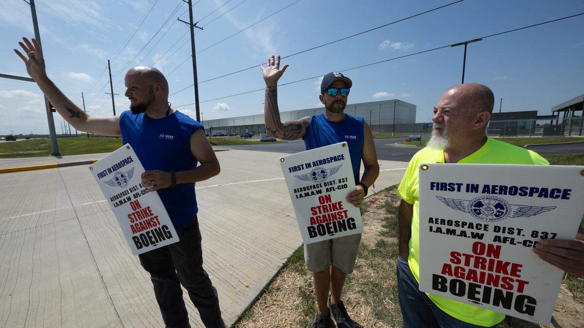 (Left to right) Ryan Lehrmann, Chris Ruhmann and Lance Webb strike outside of the Boeing facility in Mascoutah in protest of slow wage increases for newer workers.