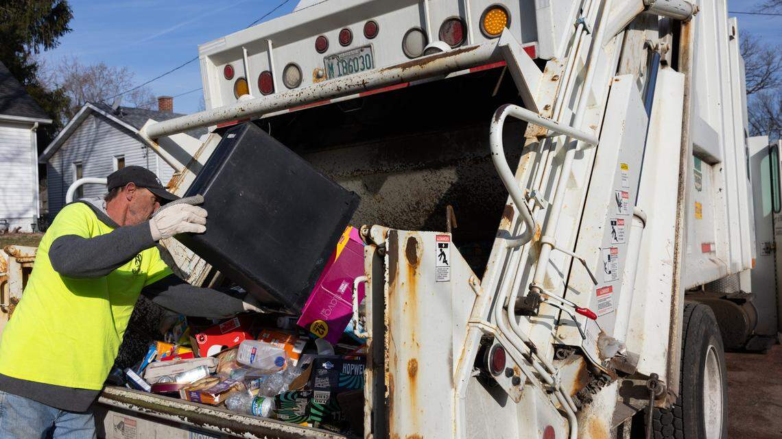 Kevin Arnold, 60, collects recyclable items on his route with a city of Belleville sanitation truck on Feb. 21, 2024.