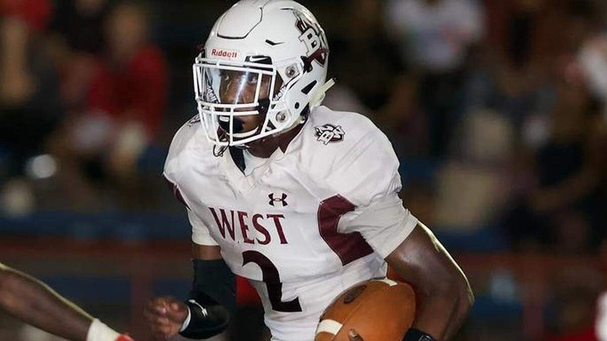 Belleville West’s Clarence Davis carries for the Maroons in a week 6 game at Alton.