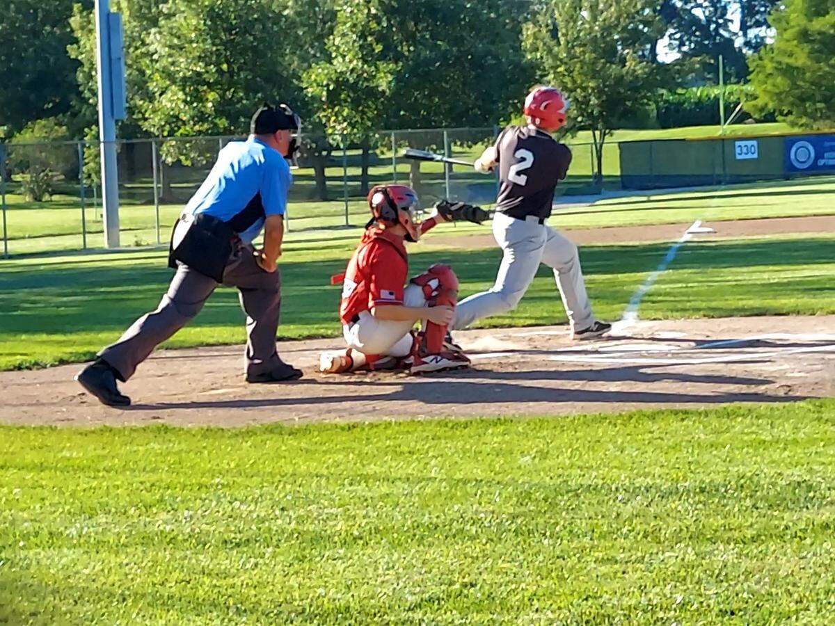 Highland Post 439 first baseman Chad Barker rips a drive toward left field during game one of the District 22 championship series Wednesday, July 20, at Glik Park in Highland. Post 439 dropped that game and then lost the nightcap to see their season end at 6-14.