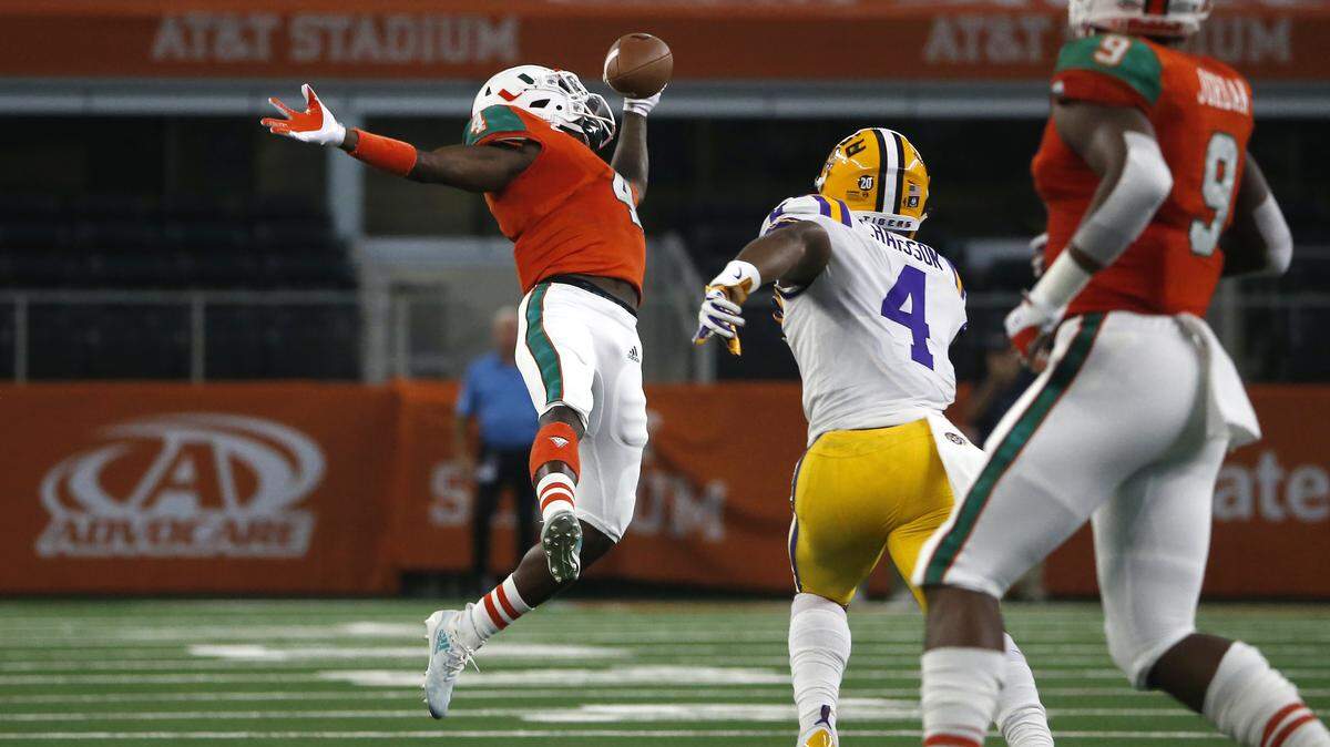 Miami wide receiver Jeff Thomas, left, makes a one-handed catch for a first down in front of LSU linebacker K’Lavon Chaisson, second from right, during the first half of an NCAA college football game Sunday, Sept. 2, 2018, in Arlington, Texas. (AP Photo/Ron Jenkins)