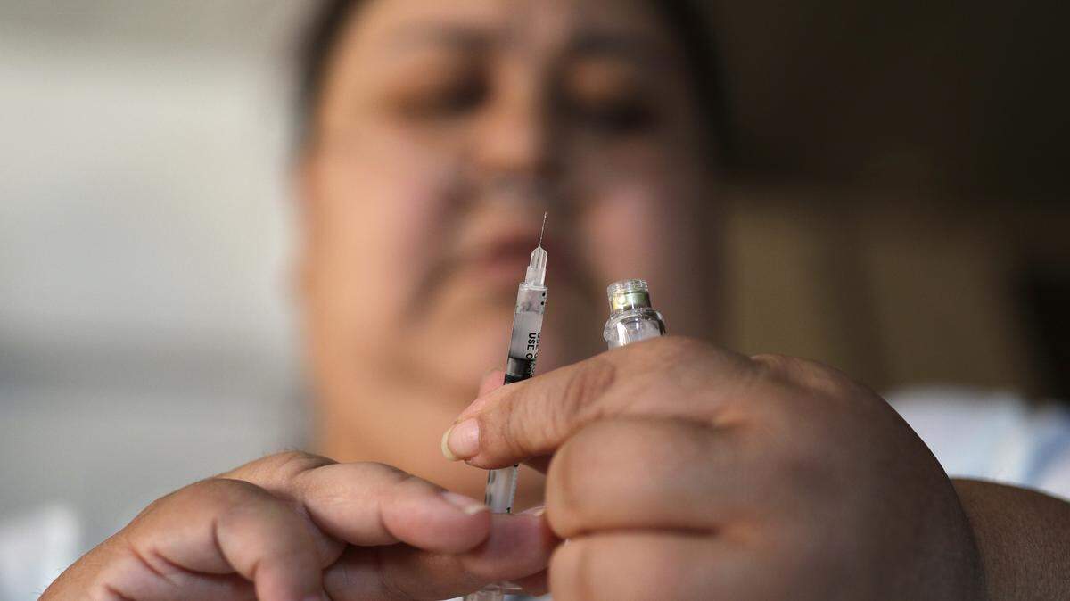 Soila Solano prepares to inject herself with insulin at her home in Las Vegas. The Build Back Better Act, which passed the U.S. House, includes multiple health care provisions, including one that would cap the out-of-pocket price of insulin at $35 a month for diabetic patients.
