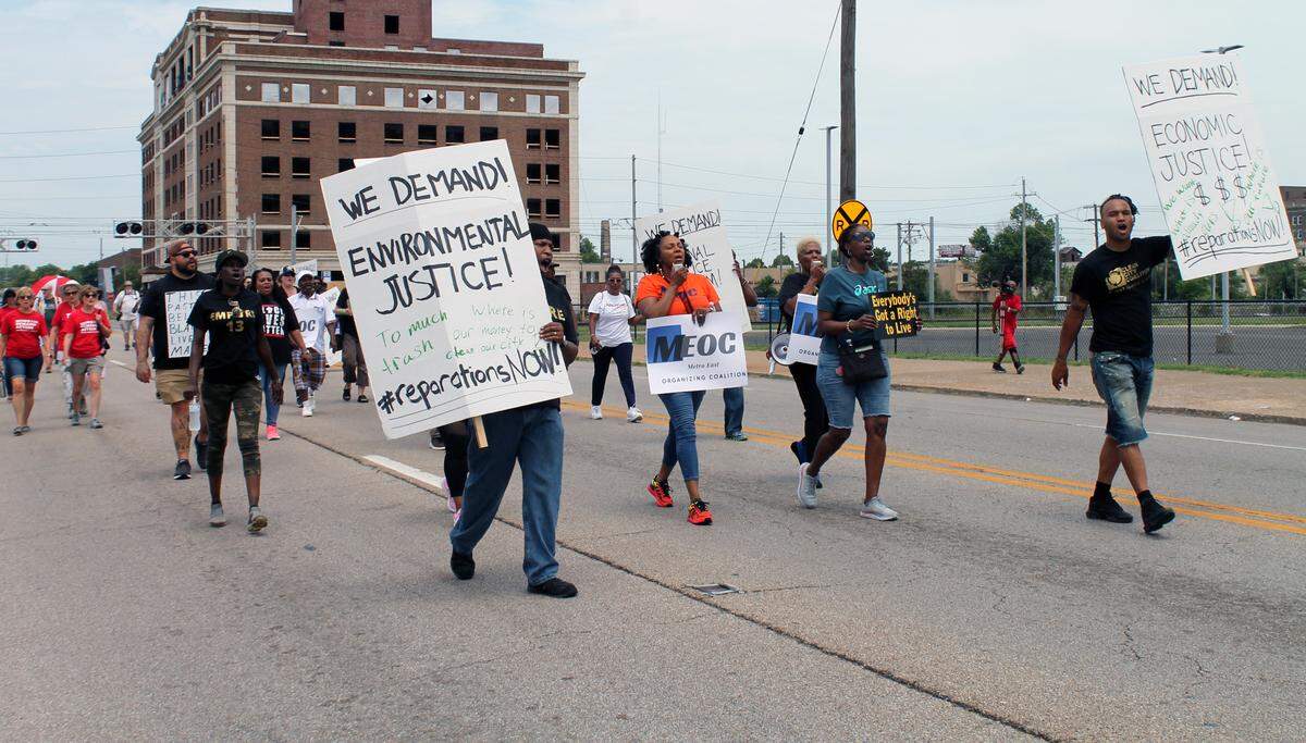 Larita Rice-Barnes (center) leads a march through East St. Louis on Saturday, July 1, the 106th anniversary of the city’s 1917 massacre. Rice-Barnes is the executive director of the community activist group Metro-East Organizing Coalition. Marchers called for reparations for relatives of the victims of the massacre.