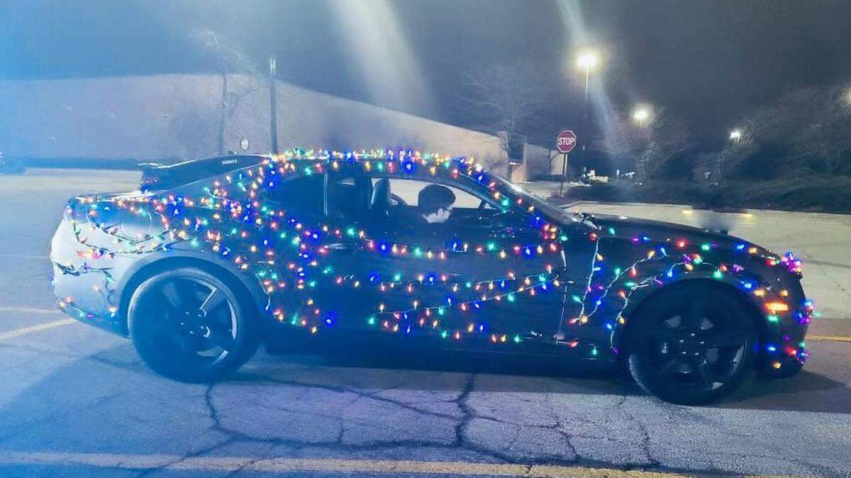 A motorists driving a Camaro covered in Christmas lights was pulled over by a state trooper for violating Wisconsin traffic laws, but many are cheering the driver's spirit.