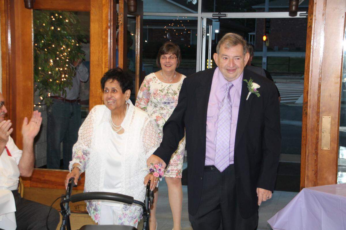 Newlyweds Julie and Joe Hubbard enter the parish hall at St. Henry's Catholic Church in Belleville for their wedding reception Friday night.