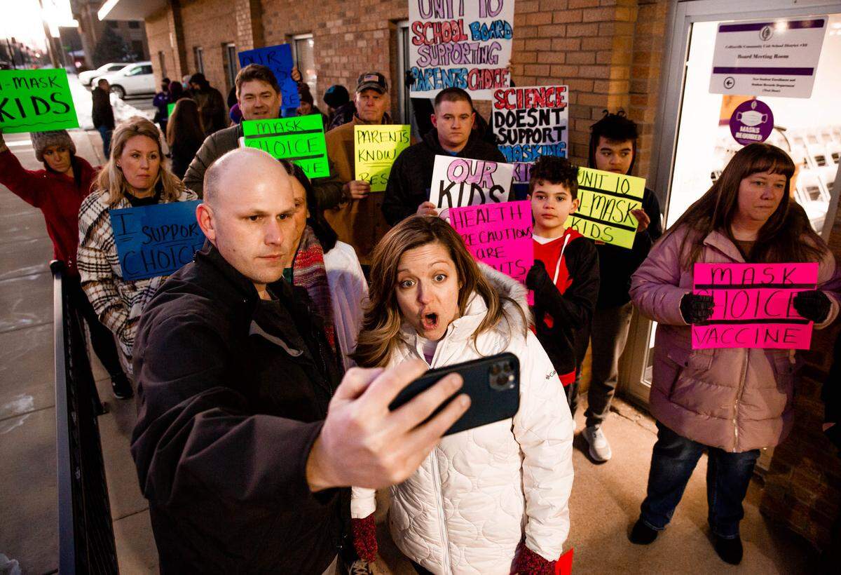 Ryan and Megan Cunningham, founders of the Troy, Illinois-based group “Speak for Students” livestream on their organization’s social media page on Monday, Feb. 7, 2022, before a school board meeting at the Collinsville CUSD 10 Administration Building