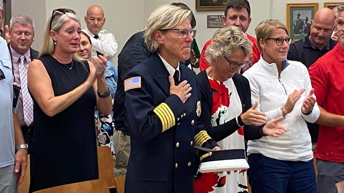 Belleville Fire Chief Stephanie Mills acknowledges the crowd’s applause at the Belleville City Hall Monday night after city council members voted to approve her appointment as fire chief.